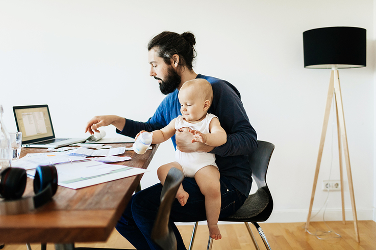 Single Father Working While Holding Baby